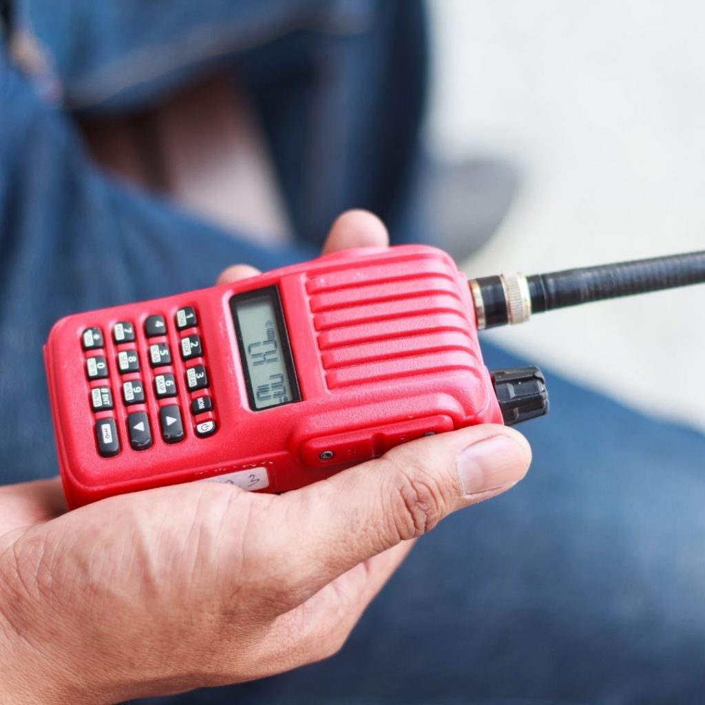 Man holding red walkie talkie