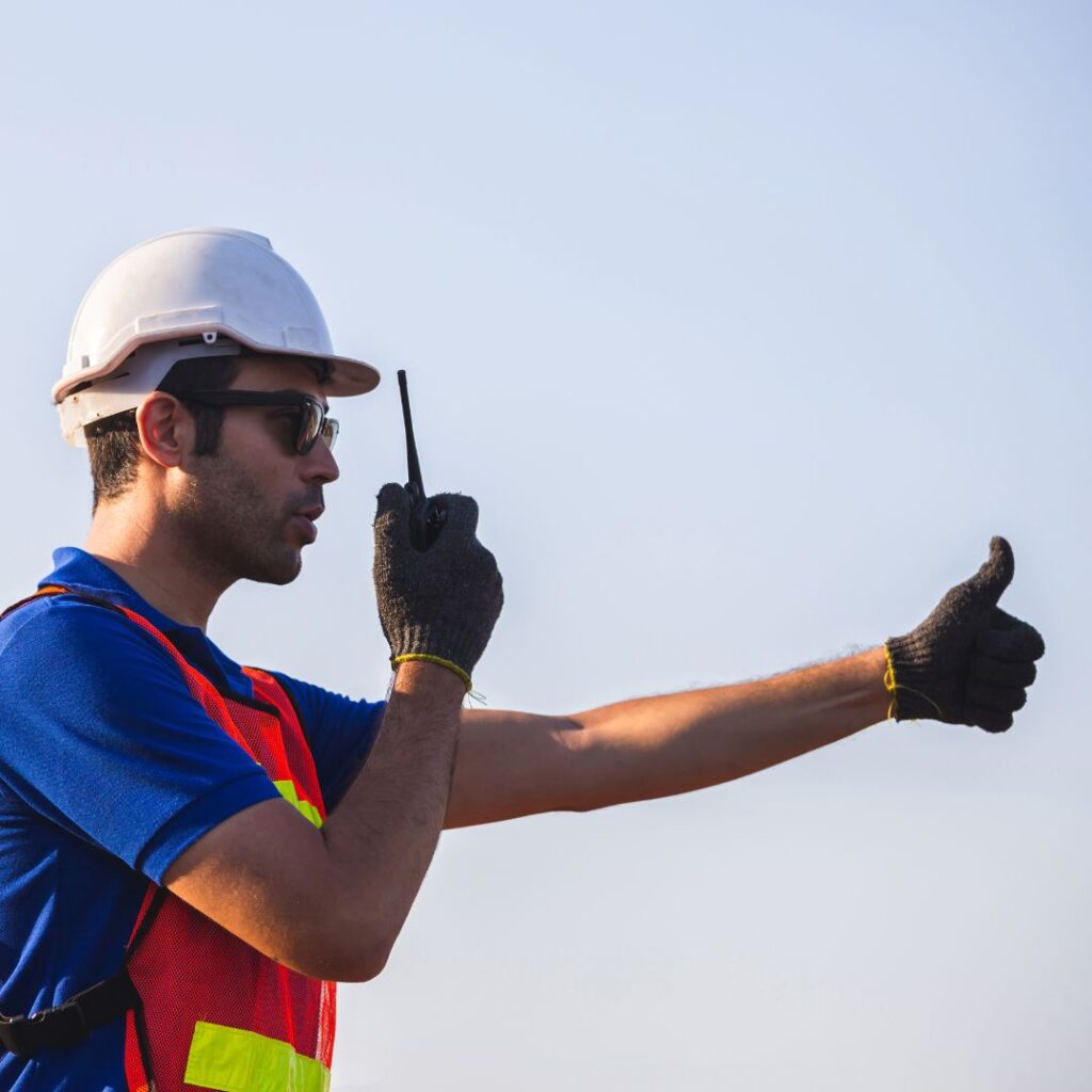 man on walkie talkie with thumbs up