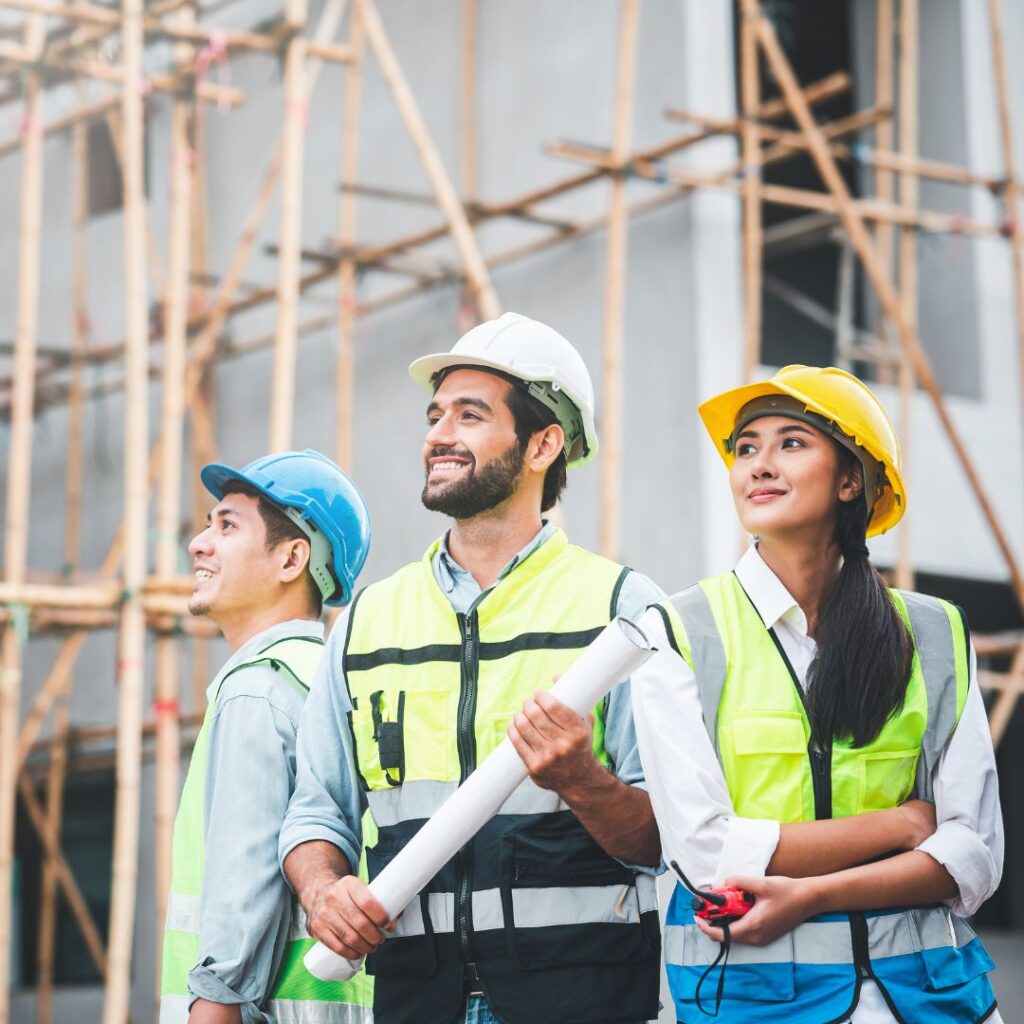 a group of construction workers looking into the distance