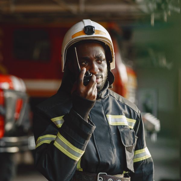 A firefighter using a walkie talkie