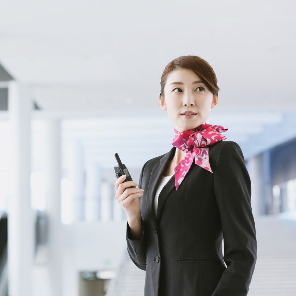 woman using two-way radio in professional clothing