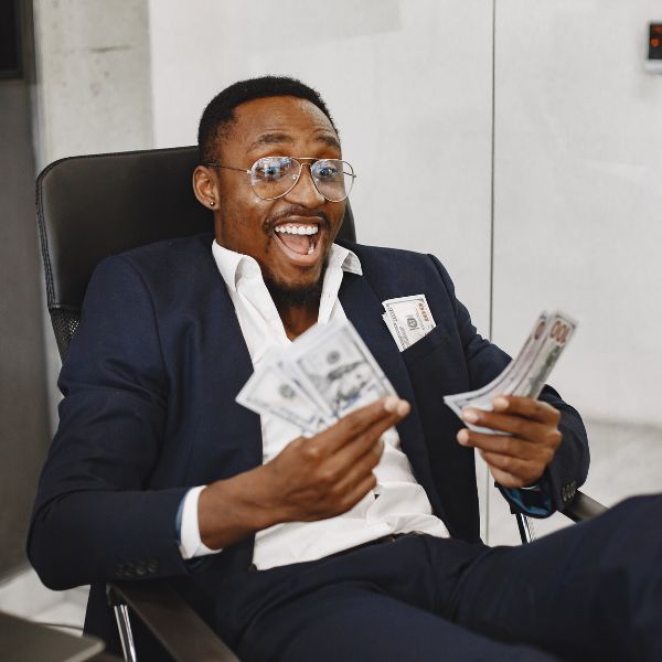 business man smiling with cash